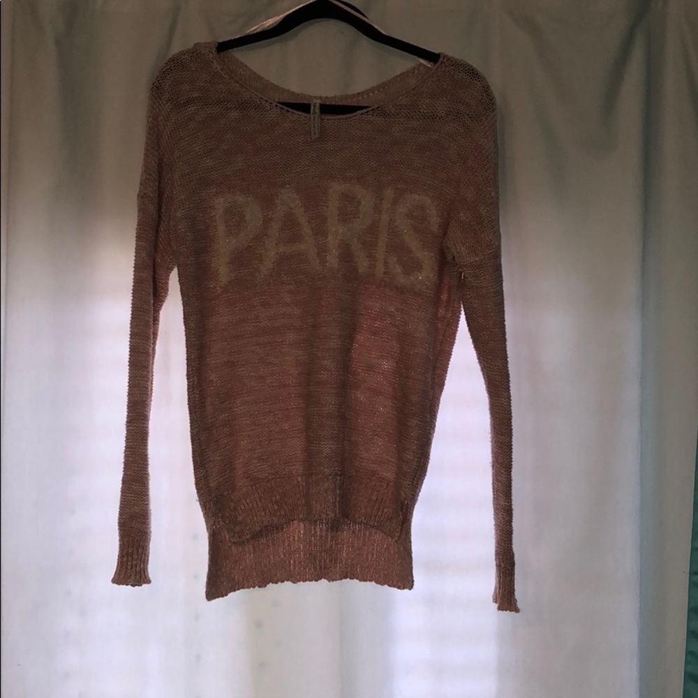 A light pink, knitted sweater